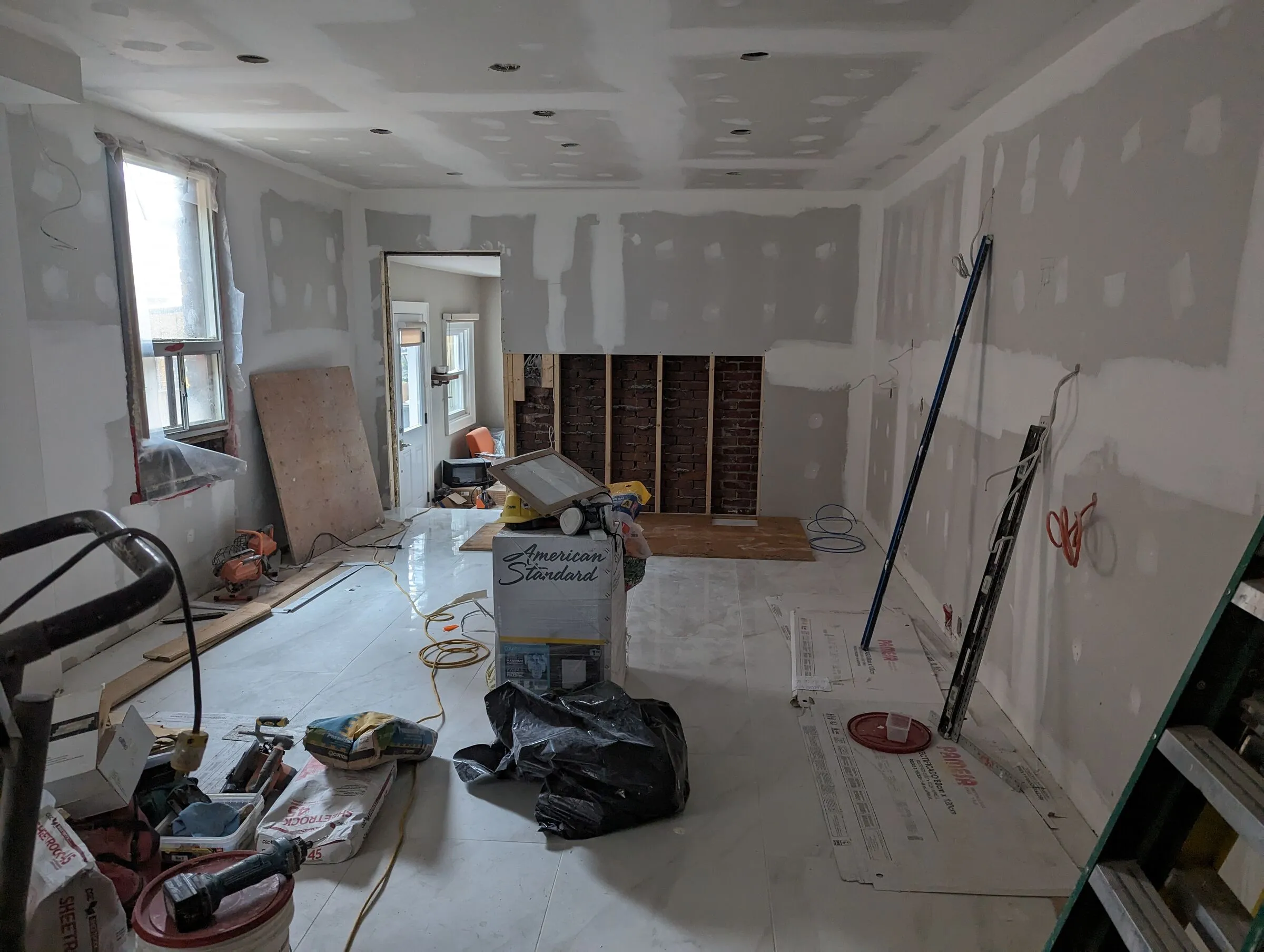 Room stripped back to drywall and framing partway through an EH Contracting Services Inc. renovation