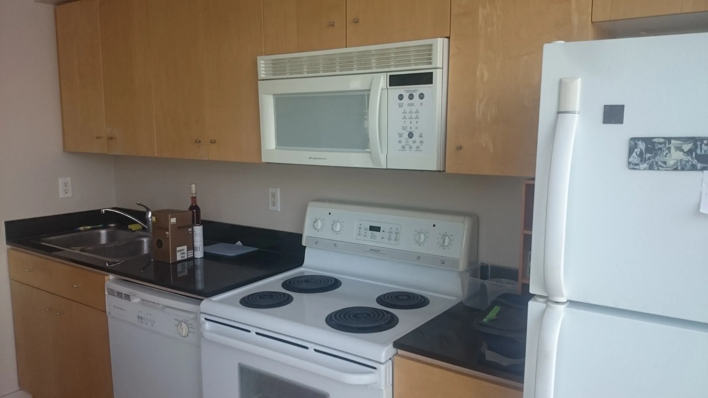 Condo kitchen being measured and planned before an EH Contracting Services Inc. renovation